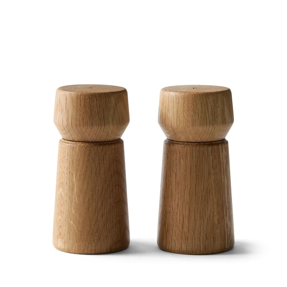 Pair of wooden salt and pepper shakers on a white background