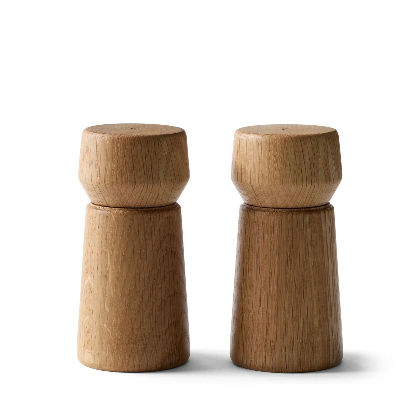 Pair of wooden salt and pepper shakers on a white background